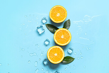 Composition with tasty oranges, leaves and ice cubes on blue background