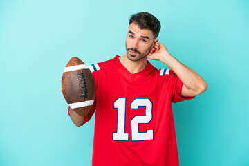 Young caucasian man playing rugby isolated on blue background having doubts