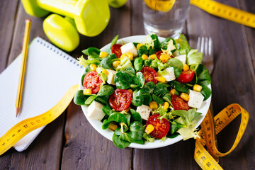 Fresh and healthy vegetable salad with feta cheese, tomatoes, and green lettuce