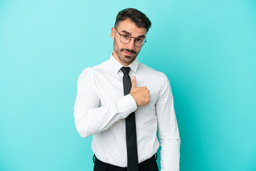 Business caucasian man isolated on blue background giving a thumbs up gesture