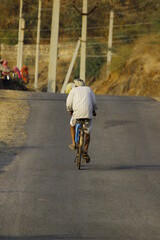 old man riding a bike 