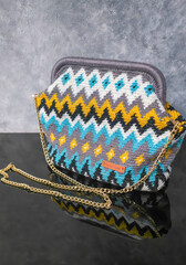 Bag crocheted from multi-colored threads Yellow with gray black and other colors