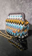 Bag crocheted from multi-colored threads Yellow with gray black and other colors
