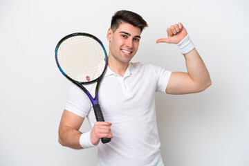 young tennis player man isolated on white background proud and self-satisfied