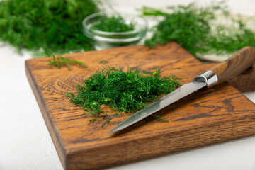 Dill on wooden background. Fresh organic greens. Dill plantation. Cut dill leaves. Bunch of spring...