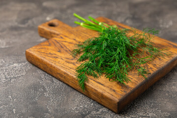 Dill on wooden background. Fresh organic greens. Dill plantation. Cut dill leaves. Bunch of spring...
