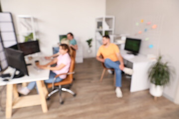 Blurred view of programmers working in office