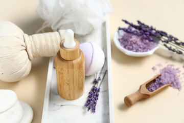 Beautiful composition with herbal bag, spa stones, lavender and bath bomb on beige background, closeup
