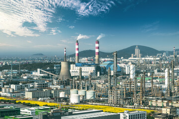Petrochemical plant and power station with smokestacks in a large industrial area.