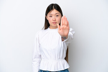 Young Chinese woman isolated on white background making stop gesture