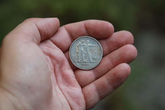 Old silver Soviet coin one ruble in hand