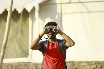boy with binoculars in the jungle
