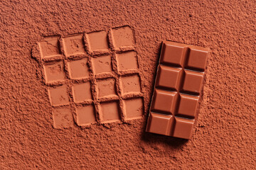 Tasty sweet chocolate on cocoa powder