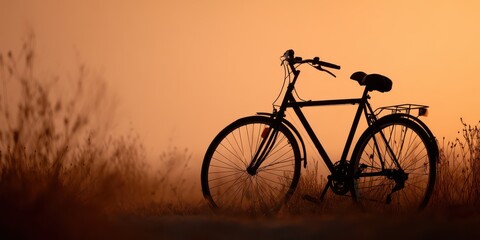 Summer vibes concept Silhouette of a bicycle against a warm sunset, surrounded by tall grass.