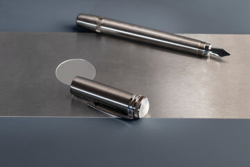Fountain pen with box on dark gray background. Stationery branded items