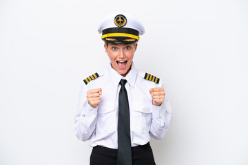 Airplane caucasian pilot woman isolated on white background celebrating a victory in winner position