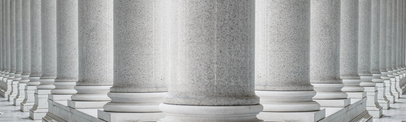 White marble columns in a neoclassical architectural style. Symmetrical row of classical marble...