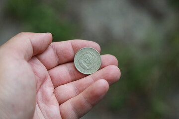 Soviet coin one ruble in hand