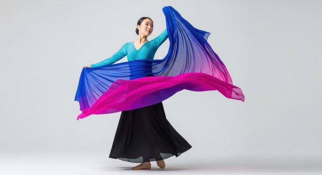 Asian young female dancer in colorful flowing dress performing graceful dance - Powered by Adobe
