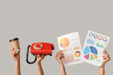 Female hands with coffee, telephone and diagrams on grey background. Time management concept