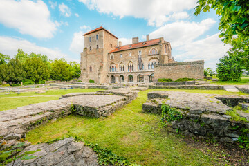 Old stone Tata Castle - 14th-century castle and museum with restored rooms and garden in Tata town,...