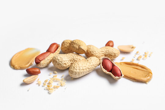 Composition with peanuts and smears of butter on light background