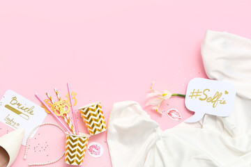 Bride's dress with decor for Hen Party on pink background