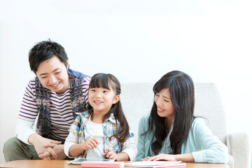 リビングで勉強を教える家族