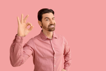 Fototapeta premium Confident Man Winking with OK Gesture
