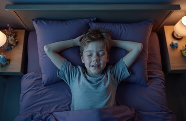 Top view of young boy sleeping soundly in bed at night, hands behind head. Peaceful child rests in cozy room, dreaming. Soft light from bedside lamp creates calm atmosphere for healthy slumber,