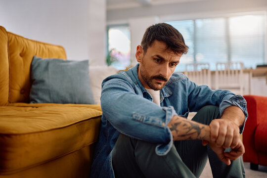 Worried man thinking of his problems at home.
