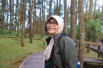 Senior Woman Enjoying a Day in the Forest with a Cheerful Smile