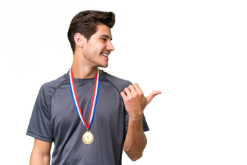 Young caucasian man with medals over isolated background pointing to the side to present a product