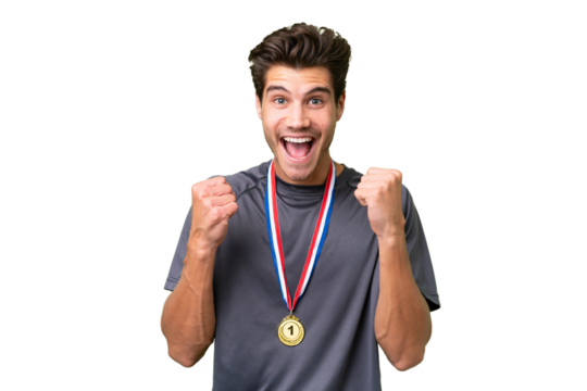 Young caucasian man with medals over isolated background celebrating a victory in winner position