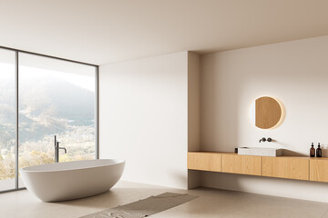 Modern minimalist bathroom interior with freestanding tub, wood vanity, and panoramic mountain view through large glass window. 3D Rendering