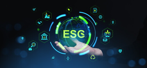 ESG sustainability concept with glowing digital globe and green icons hovering above open hand on...