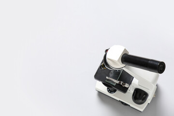 Modern microscope on white background, top view