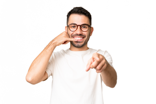 Young handsome caucasian man over isolated chroma key background making phone gesture and pointing front