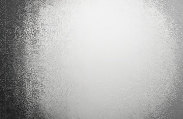 Obraz premium Monochrome halftone dots create textured background with subtle fade effect. Abstract, grainy pattern resembles dust sand overlay, suitable for vintage grunge designs. Dotwork creates digital noise