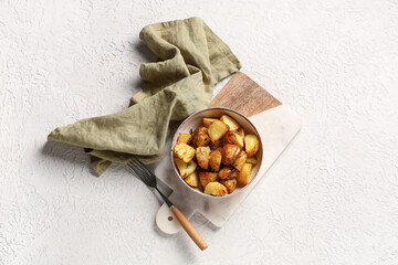 Bowl with baked baby potatoes on white background