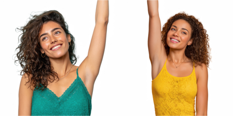 Two smiling women with curly hair raising arms wearing lace tank tops on black background