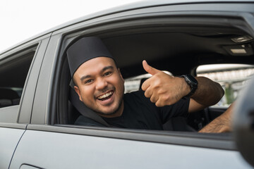 Asian muslim business man getting new car. Happy and excited. Smiling man islamic driving vehicle...