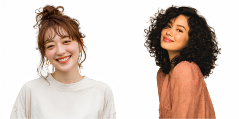 Two women smiling with different hairstyles and skin tones posing for the camera