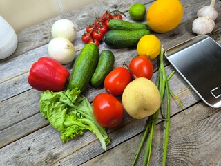 Culinary background with an assortment of fresh organic vegetables next to the scales. View from above. high-quality photo