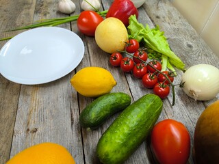 Culinary background with an assortment of fresh organic vegetables next to the plate. View from above. high-quality photo