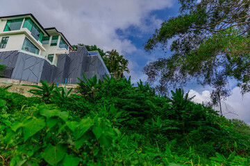 House perched on top of a hill in the mountains of Kalim overlooking the Andaman sea and Patong Beach on the island of Phuket Thailand
