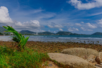 View of Patong Beach in the island of Phuket Thailand, turquoise blue waters of the Andaman and lush green mountains
