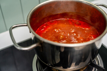 Rich tomato sauce simmer gently in a pot coat pasta. Thick vibrant tomato sauce bubbles in a pan filling the kitchen. Homemade tomato sauce bubbling beautifully on the stove awaits its pasta pairing