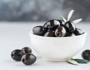 A white bowl of black olives of Spanish origin