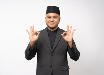 Portrait happy young asian muslim man in suit on isolated white background. Islamic Attractive Muslim man wearing songkok cap islam costume.